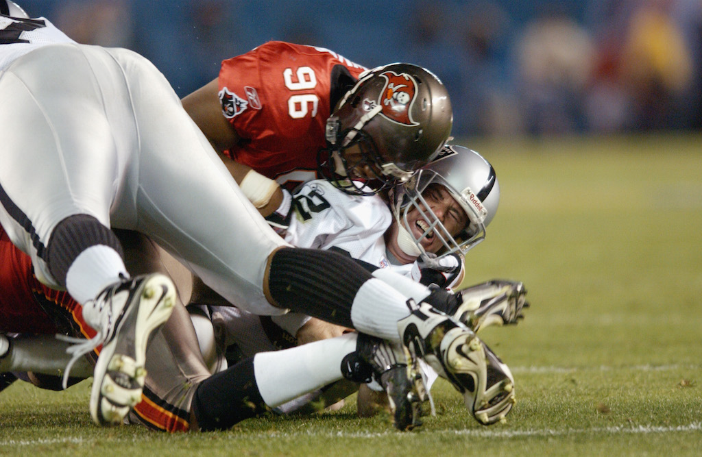 Ellis Wyms #96 of the Tampa Bay Buccaneers sacks quarterback Rich Gannon #12 of the Oakland Raiders in Super Bowl XXXVII