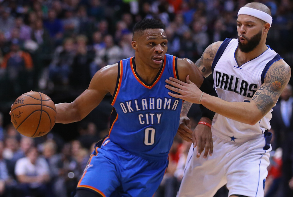 Russell Westbrook (L) drives past Deron Williams
