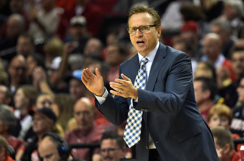 Scott Brooks cheers from the sidelines at a game.