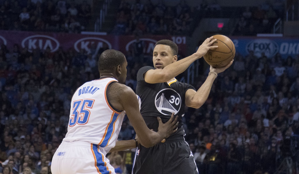 OKLAHOMA CITY, OK - FEBRUARY 27: Stephen Curry #30 of the Golden State Warriors looks for a play as Kevin Durant #35 of the Oklahoma City Thunder apples pressure during the first quarter of a NBA game at the Chesapeake Energy Arena on February 27, 2016 in Oklahoma City, Oklahoma. NOTE TO USER: User expressly acknowledges and agrees that, by downloading and or using this photograph, User is consenting to the terms and conditions of the Getty Images License Agreement.