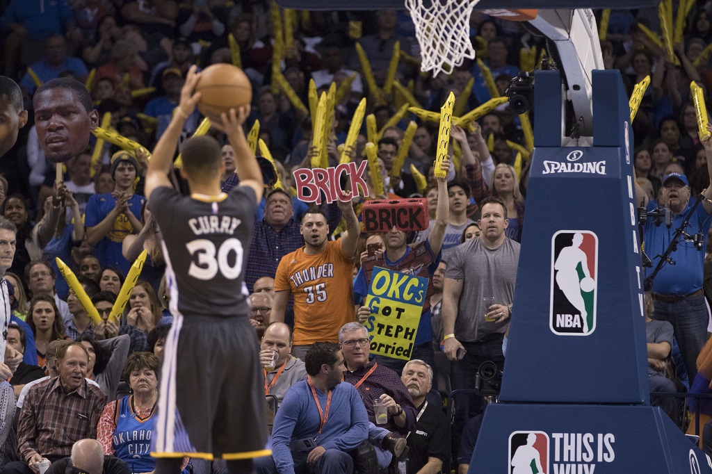 OKLAHOMA CITY, OK - FEBRUARY 27: Oklahoma City Thunder fans try to distract Stephen Curry #30 of the Golden State Warriors as he shoots a free throw during the third period of a NBA game at the Chesapeake Energy Arena on February 27, 2016 in Oklahoma City, Oklahoma. The Warriors won 121-118 in overtime.