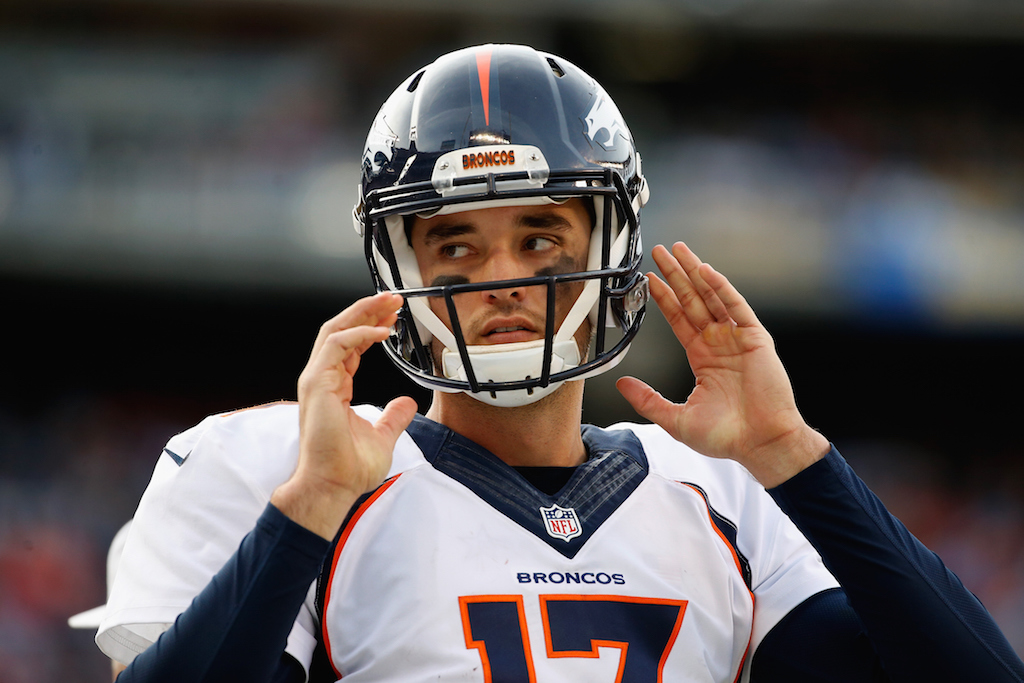 Brock Osweiler removes his helmet during a game.
