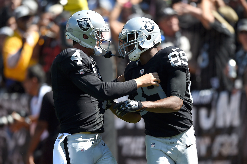 Thearon W. Henderson/Getty ImagesOAKLAND, CA - SEPTEMBER 20: Derek Carr #4 of the Oakland Raiders celebrates a touchdown with Amari Cooper #89 of the Oakland Raiders in the first quarter against the Baltimore Ravens at Oakland-Alameda County Coliseum on September 20, 2015 in Oakland, California. (Photo by Thearon W. Henderson/Getty Images)