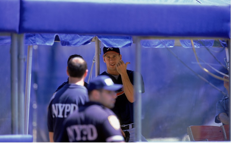 Pitcher John Rocker of the Atlanta Braves waits with his NYPD escort during the game against the New York Mets