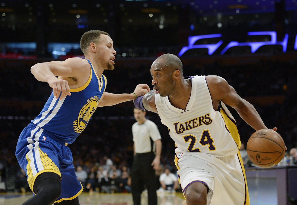 Kobe Bryant drives on Stephen Curry.