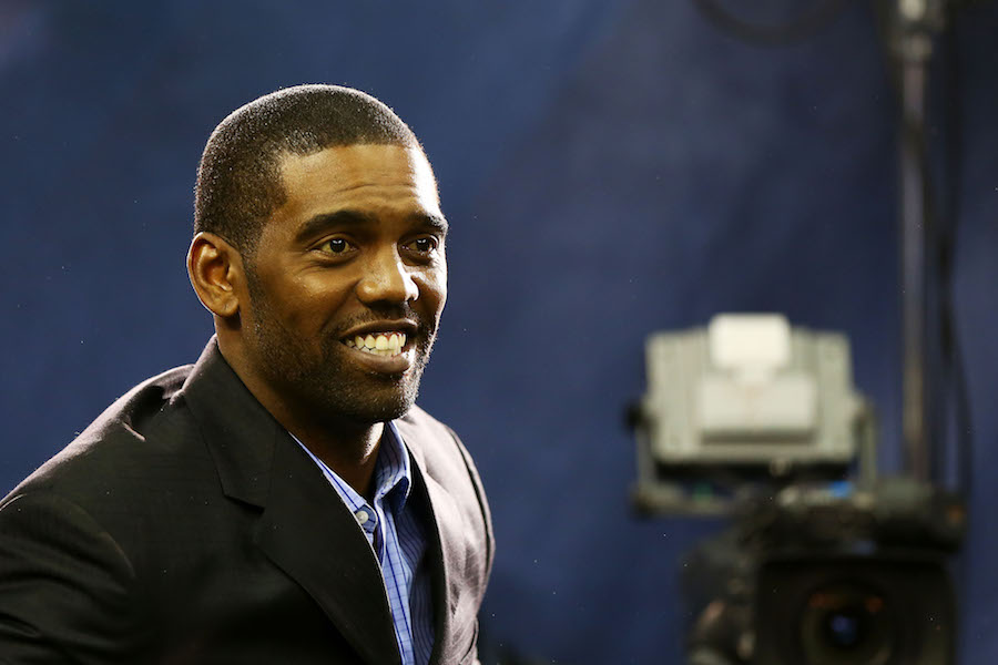 Randy Moss smiles during a press conference.