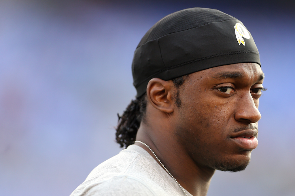 Quarterback Robert Griffin III of the Washington Redskins looks on prior to the start of a preseason game. | Matt Hazlett/ Getty Images