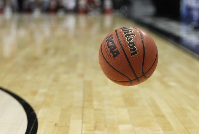 A basketball bouncing on a court. A basketball bouncing on a court.