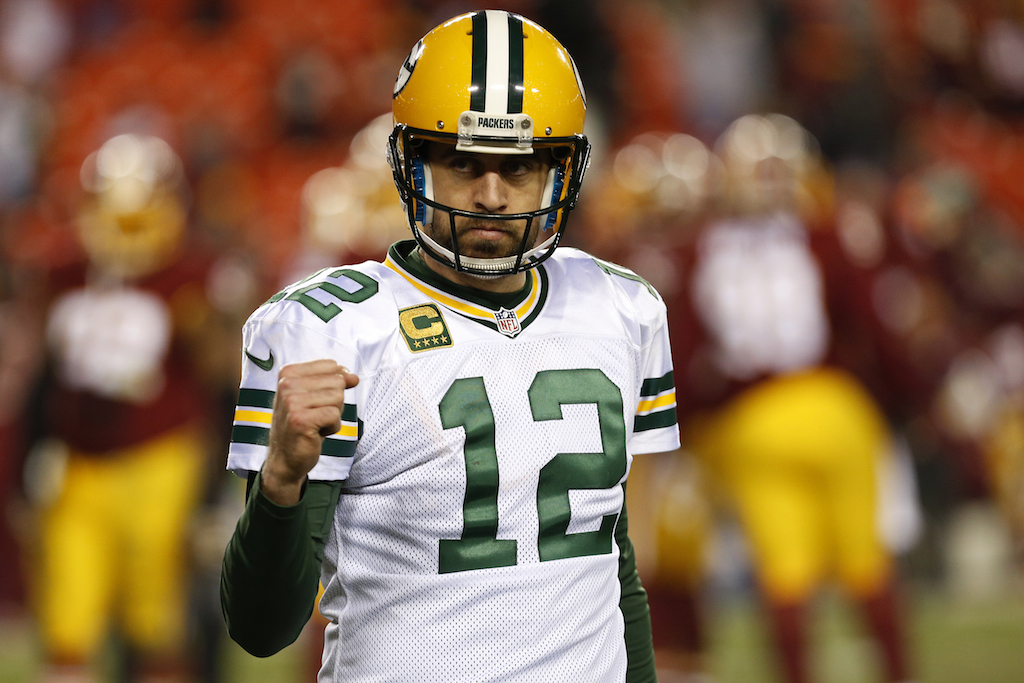 Aaron Rodgers fist pumps after throwing a touchdown pass.