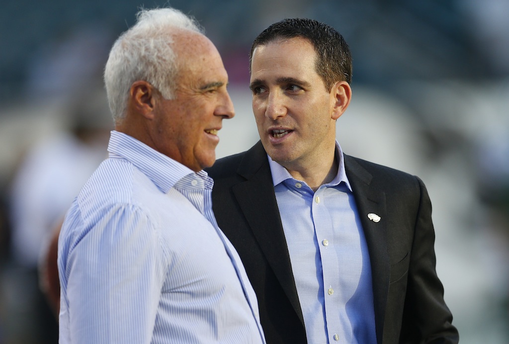 Philadelphia Eagles owner Jeffrey Lurie (L) speaks with Howie Roseman. | Rich Schultz/Getty Images