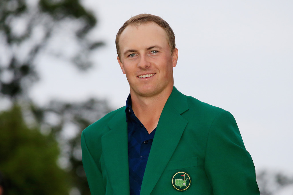 Jordan Spieth smiling while in a green jacket.