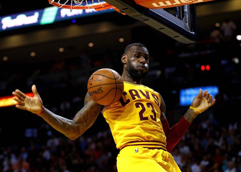 LeBron James dunks against the Miami Heat. | Mike Ehrmann/Getty Images