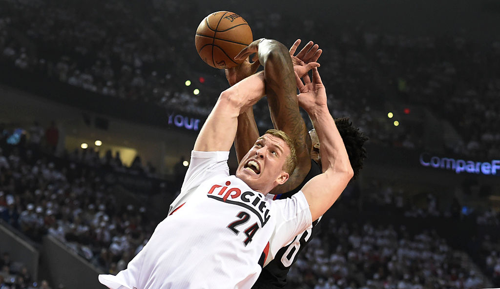 Mason Plumlee of the Portland Trail Blazers goes for the ball against his opponent.