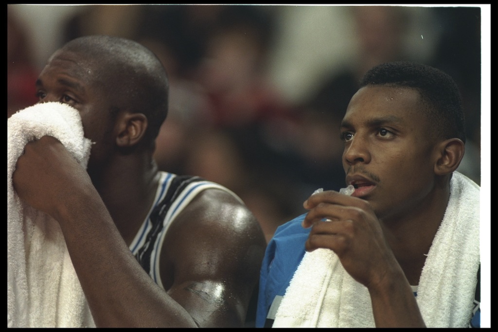 Shaquille O'Neal and Penny Hardaway sit on the Magic bench.
