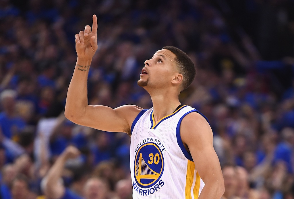 Stephen Curry gestures to the sky during a game against the Grizzlies. | Thearon W. Henderson/Getty Images