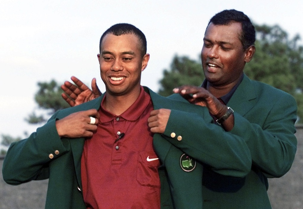 Tiger Woods receives the green jacket after winning The Masters. 