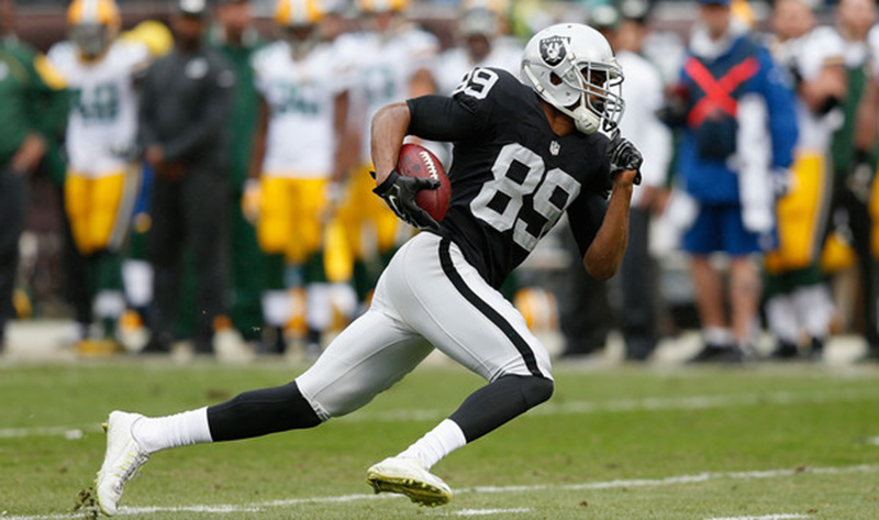 Amari Cooper grips the football and runs for the end zone.