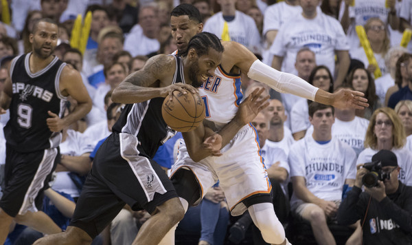 Oklahoma City's Andre Roberson defends San Antonio's Kawhi Leonard. | J Pat Carter/Getty Images Thunder