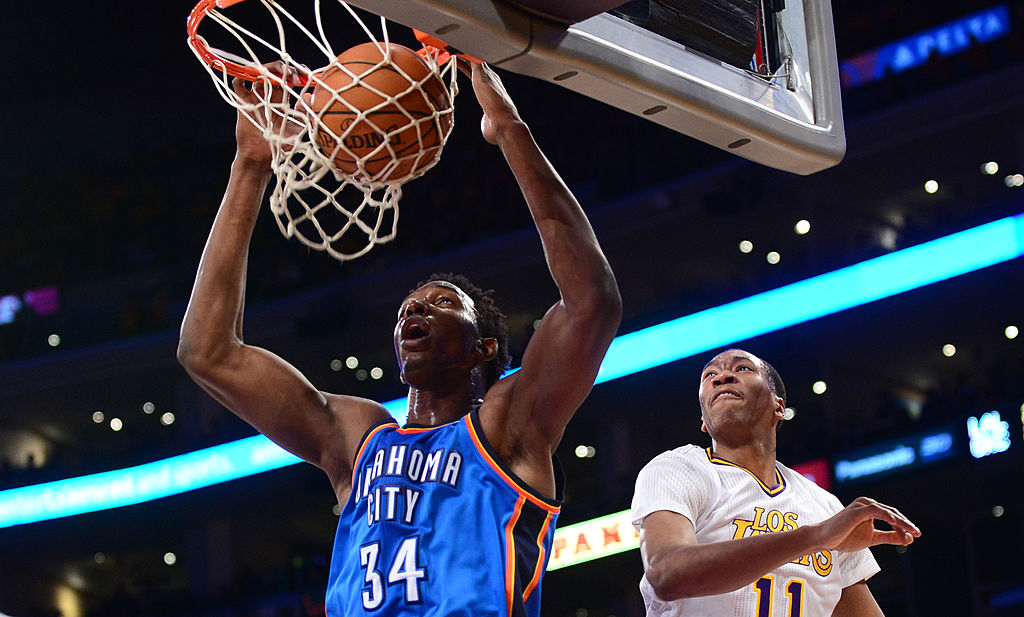 Hasheem Thabeet of the Oklahoma City Thunder scores under pressure from Wesley Johnson of the Los Angeles Lakers during their NBA matchup at Staples Center in Los Angeles, California on March 9, 2014. AFP PHOTO/Frederic J. BROWN (Photo credit should read FREDERIC J. BROWN/AFP/Getty Images)