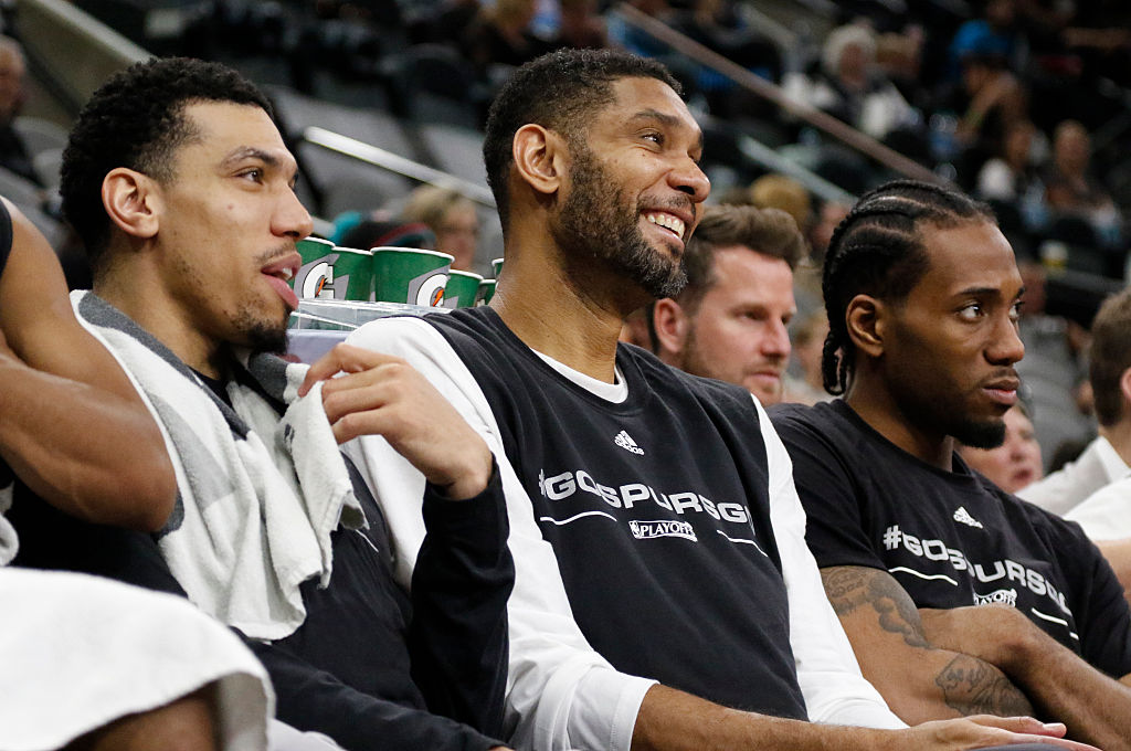 Danny Green #14 of the San Antonio Spurs jokes with Tim Duncan #21 during the fourth quarter of Game One of the Western Conference Quarterfinals against the Memphis Grizzlies during the 2016 NBA Playoffs at AT&T Center on April 17, 2016 in San Antonio, Texas.