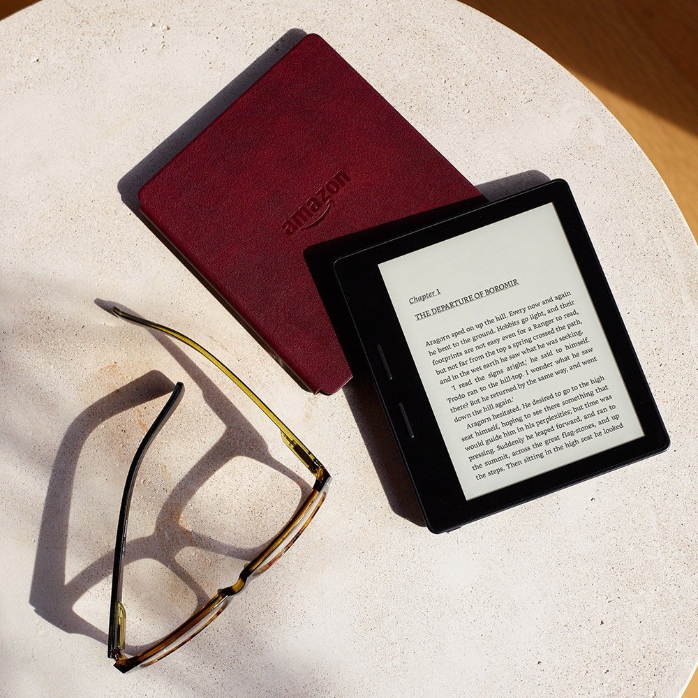 amazon kindle and a pair of reading glasses Amazon Kindle Oasis ebook readers