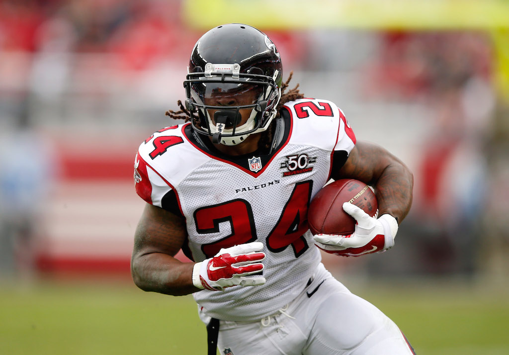 Devonta Freeman grips the ball and makes a run for it.