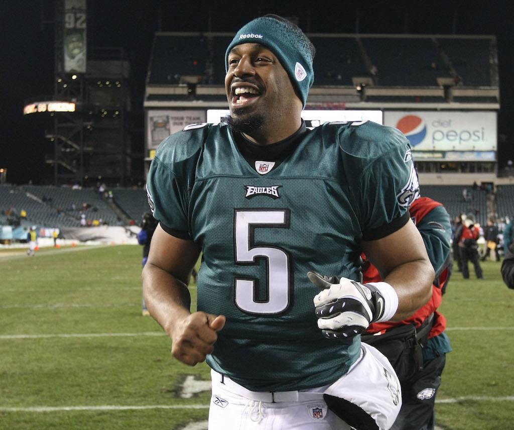 Donovan McNabb smiles as he runs off the field.