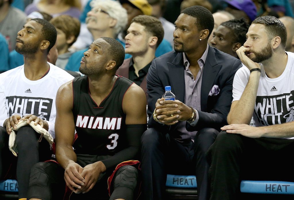 Dwyane Wade and Chris Bosh watch from the Miami sideline.