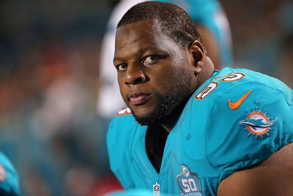 Ndamukong Suh watches from the sideline.