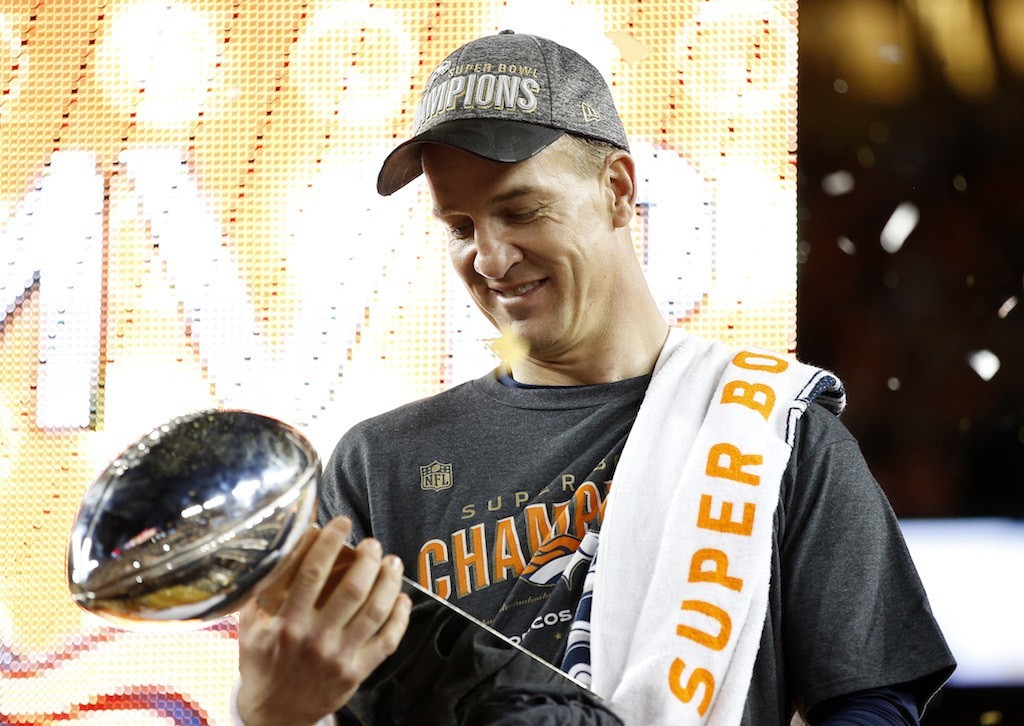 Peyton Manning admires his Super Bowl trophy.