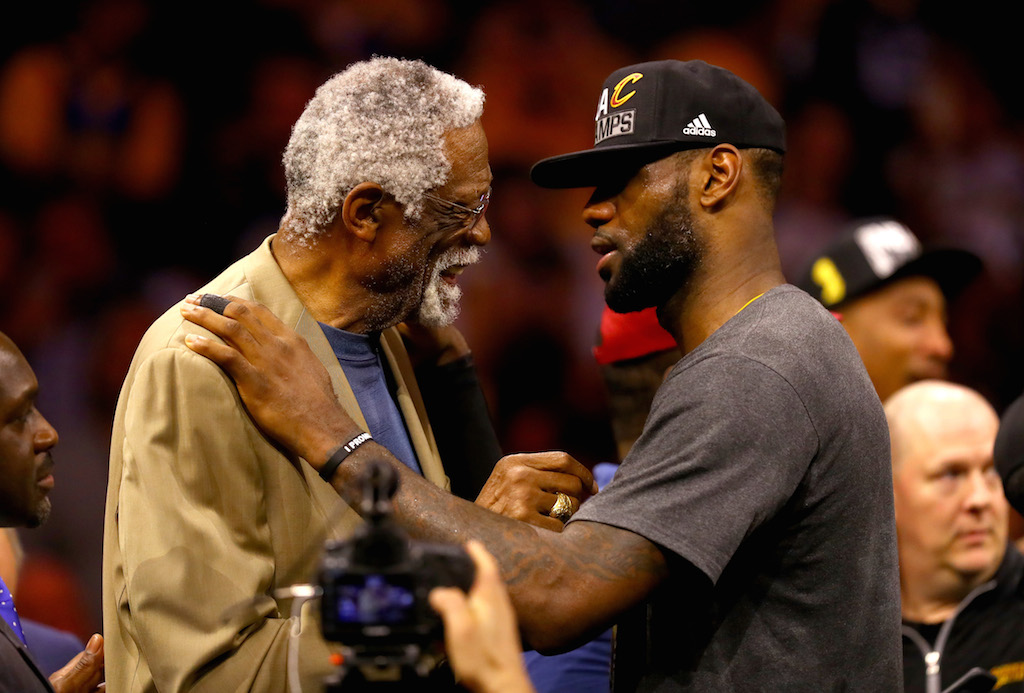Bill Russell (L) and LeBron James embrace.