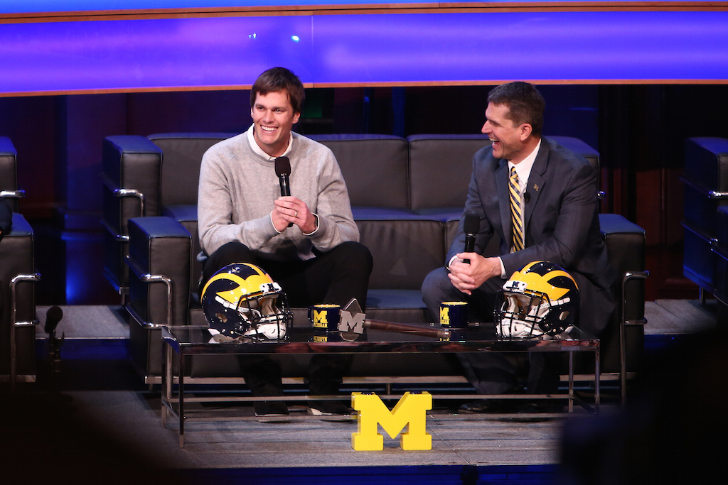 Tom Brady (L) chats with Jim Harbaugh during the Michigan Signing of the Stars event.