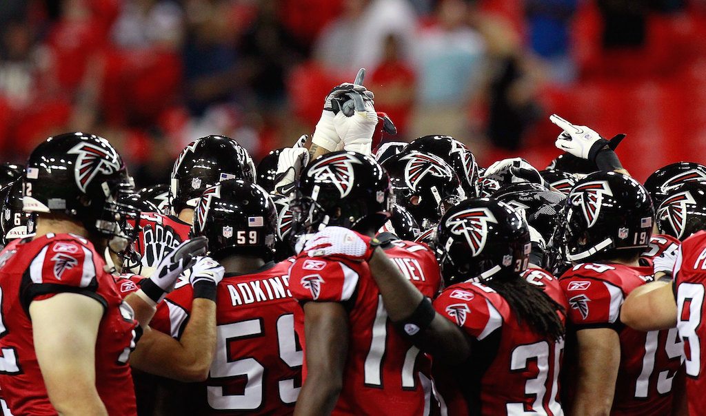 The Atlanta Falcons huddle up to begin a game.