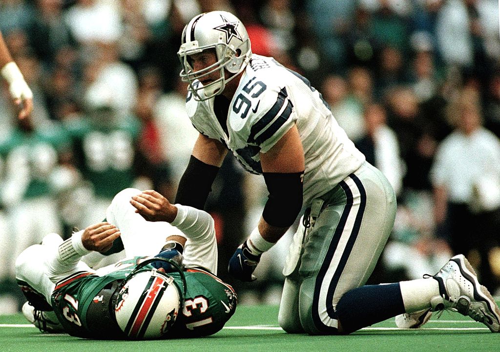Dallas Cowboys defensive tackle Chad Hennings puts Miami Dolphins quarterback Dan Marino on the ground.