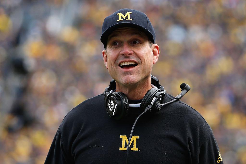 Head coach Jim Harbaugh of the Michigan Wolverines celebrates a touchdown.