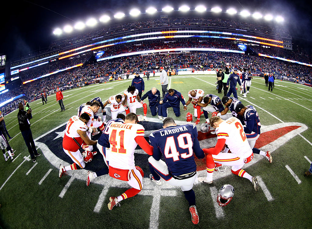 Players from the Kansas City Chiefs and New England Patriots, including No. 49 Joe Cardona, gather at mid-field after the AFC Divisional Playoff Game in 2016. 