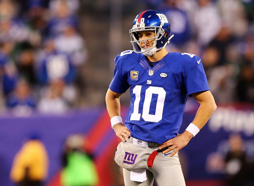 Eli Manning stands on the field between plays.