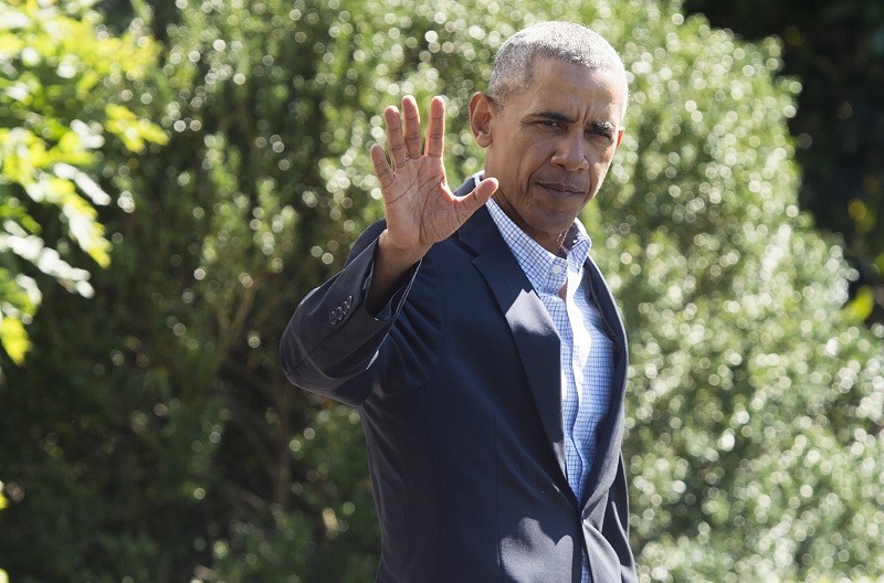 Former President Barack Obama walks across the White House lawn.