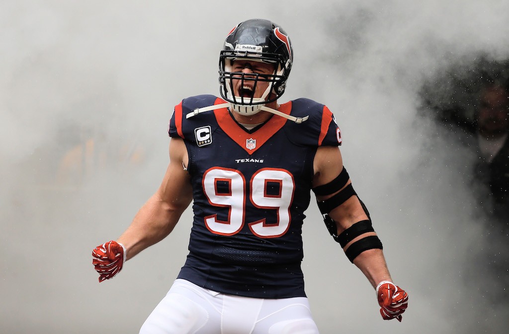 An excited J.J. Watt emerges from the locker room hall to begin a game.