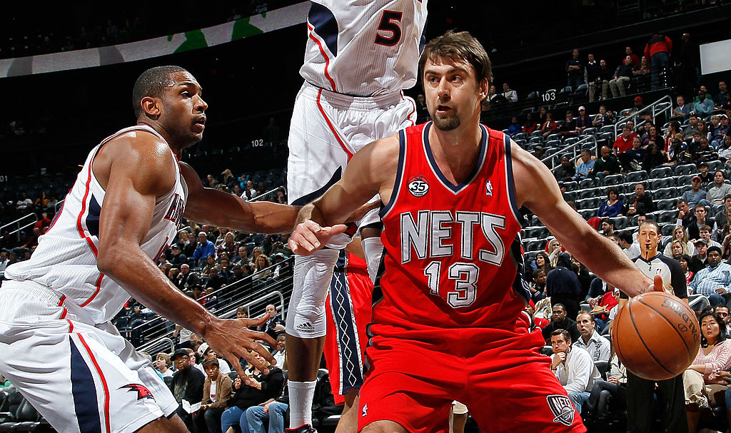 Al Horford of the Atlanta Hawks against Mehmet Okur of the New Jersey Nets battle on the court.