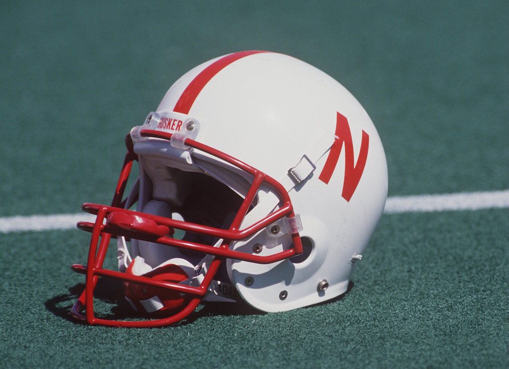 A Nebraska helmet rests on the field.