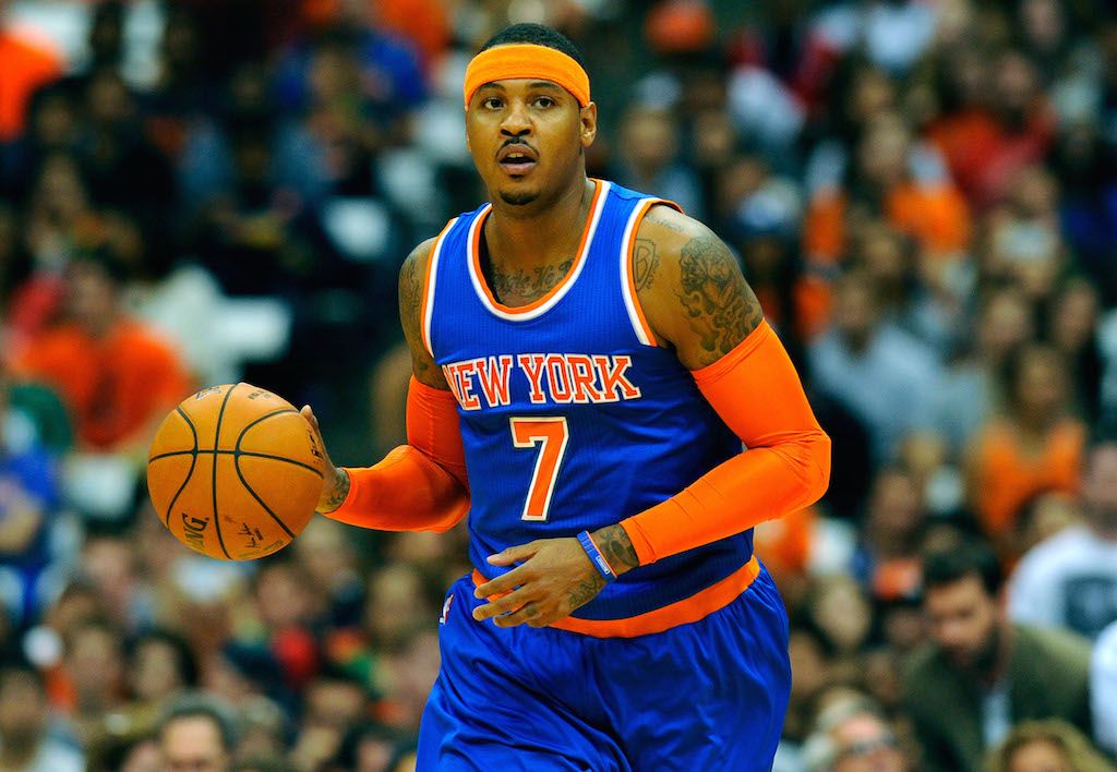 Carmelo Anthony looks to his teammates as he dribbles down the court.