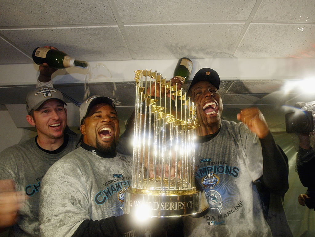 Florida Marlins players celebrate with the World Series Trophy after defeating the New York Yankees in game six of the Major League Baseball World Series on October 25, 2003 at Yankee Stadium in the Bronx, New York. The Marlins won 2-0.