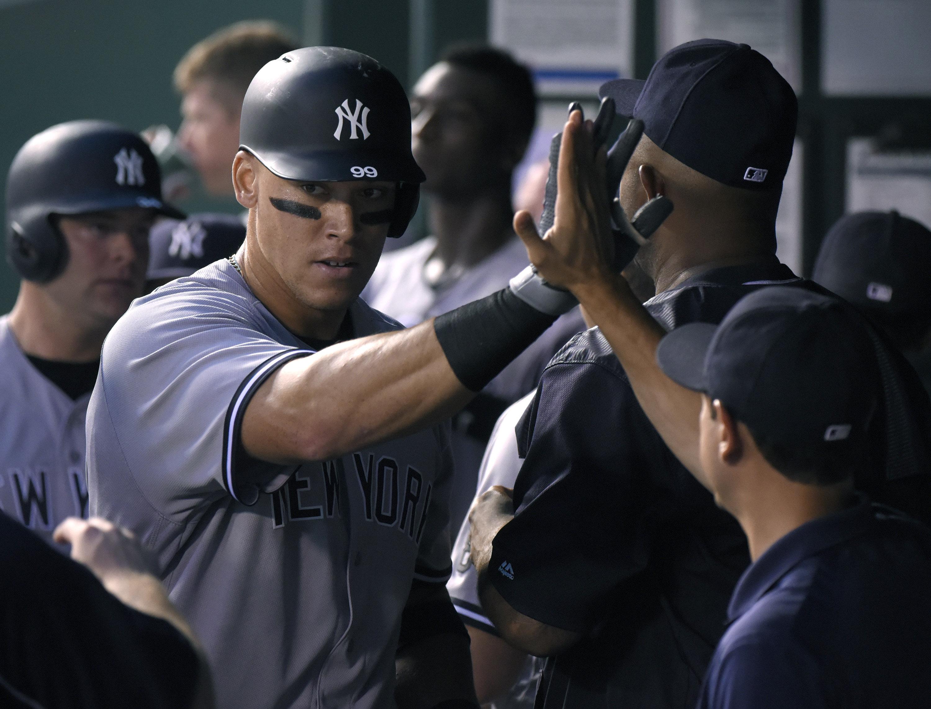 KANSAS CITY, MO - AUGUST 30: Aaron Judge #99 of the New York Yankees is congratulated by teammates after hitting a two-run home run against the Kansas City Royals in the second inning at Kauffman Stadium on August 30, 2016 in Kansas City, Missouri. (Photo by Ed Zurga/Getty Images)