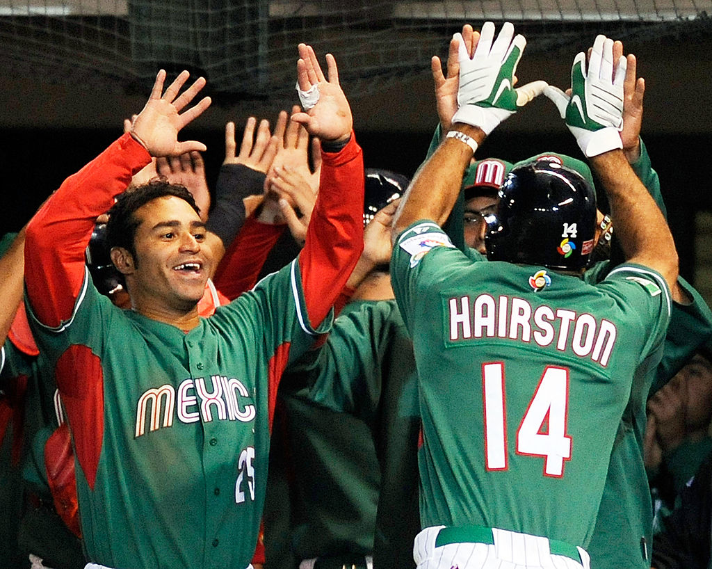Scott Hairston #14 of Mexico is congratulated by teammates after hitting a two-run home run against Australia during the World Baseball Classic.
