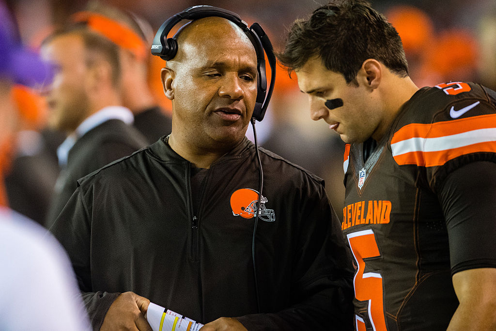 Head coach Hue Jackson talks with quarterback Cody Kessler.