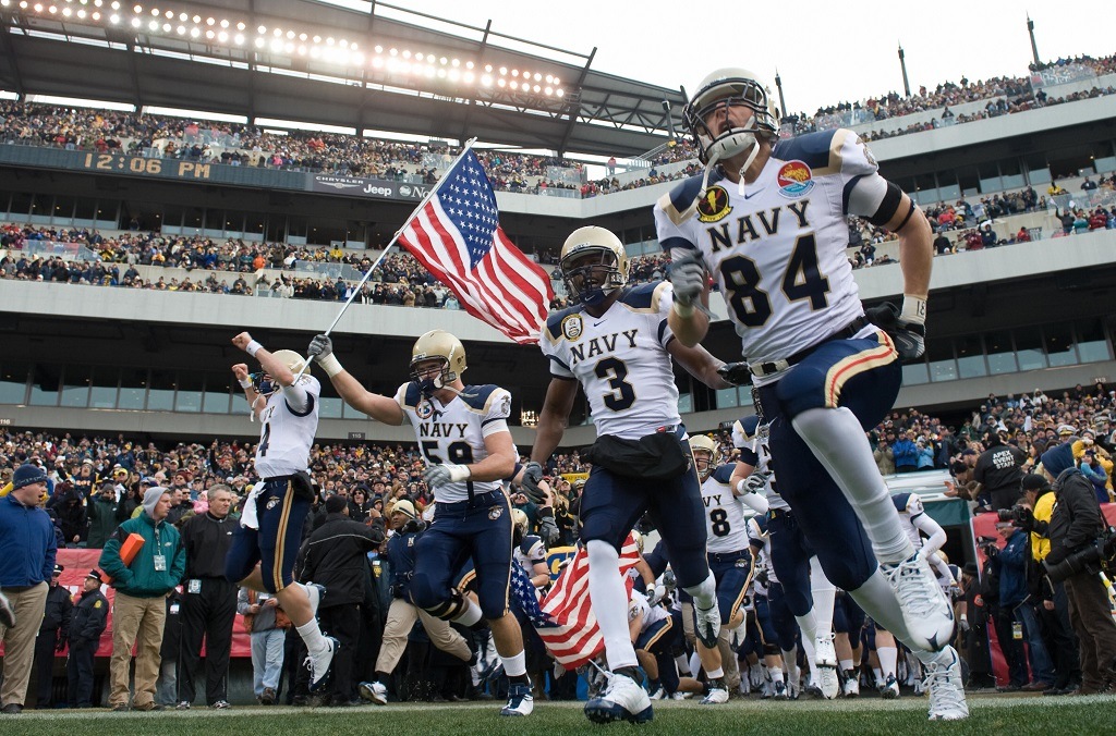 Members of the Navy football team run out onto the field prior to the Army vs. Navy football game attended by US President George W. Bush at Lincoln Financial Field in Philadelphia, Pennsylvania, on December 6, 2008. AFP PHOTO / Saul LOEB (Photo credit should read SAUL LOEB/AFP/Getty Images)