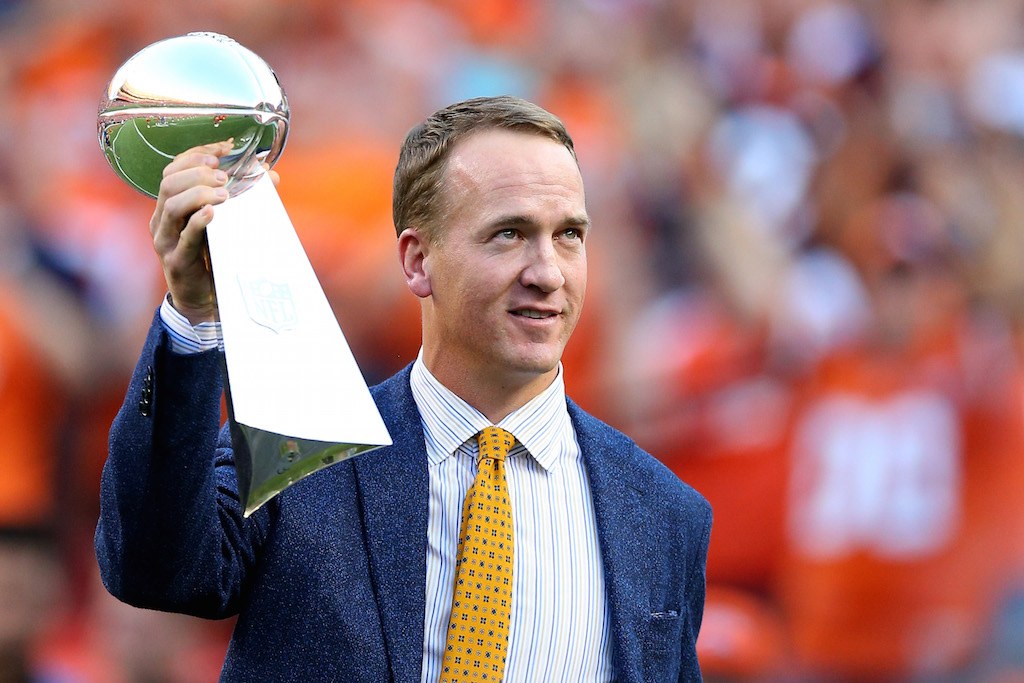Peyton Manning hoists the Super Bowl 50 Lombardi Trophy in Denver, Colo.
