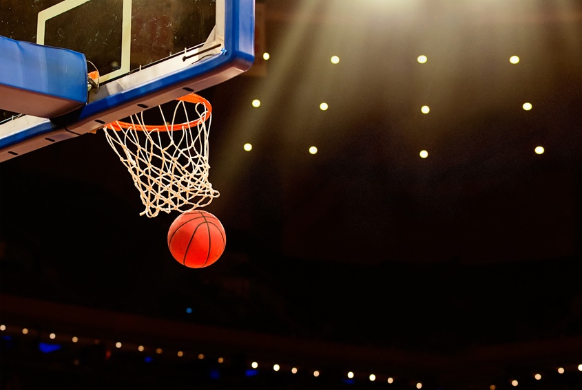 A ball swishes through the net at a basketball game. A ball swishes through the net at a basketball game.