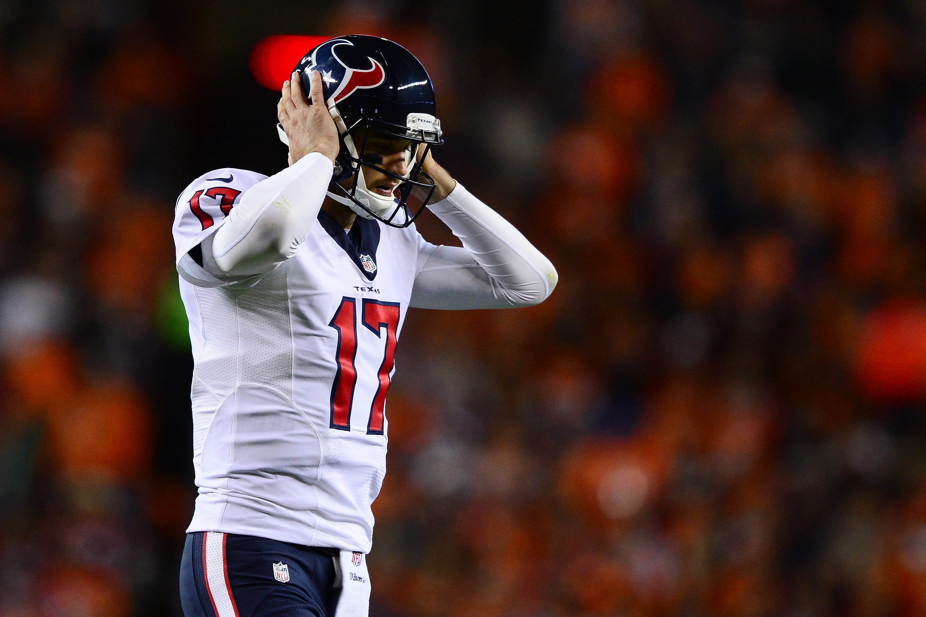 Brock Osweiler grips his helmet after an interception.